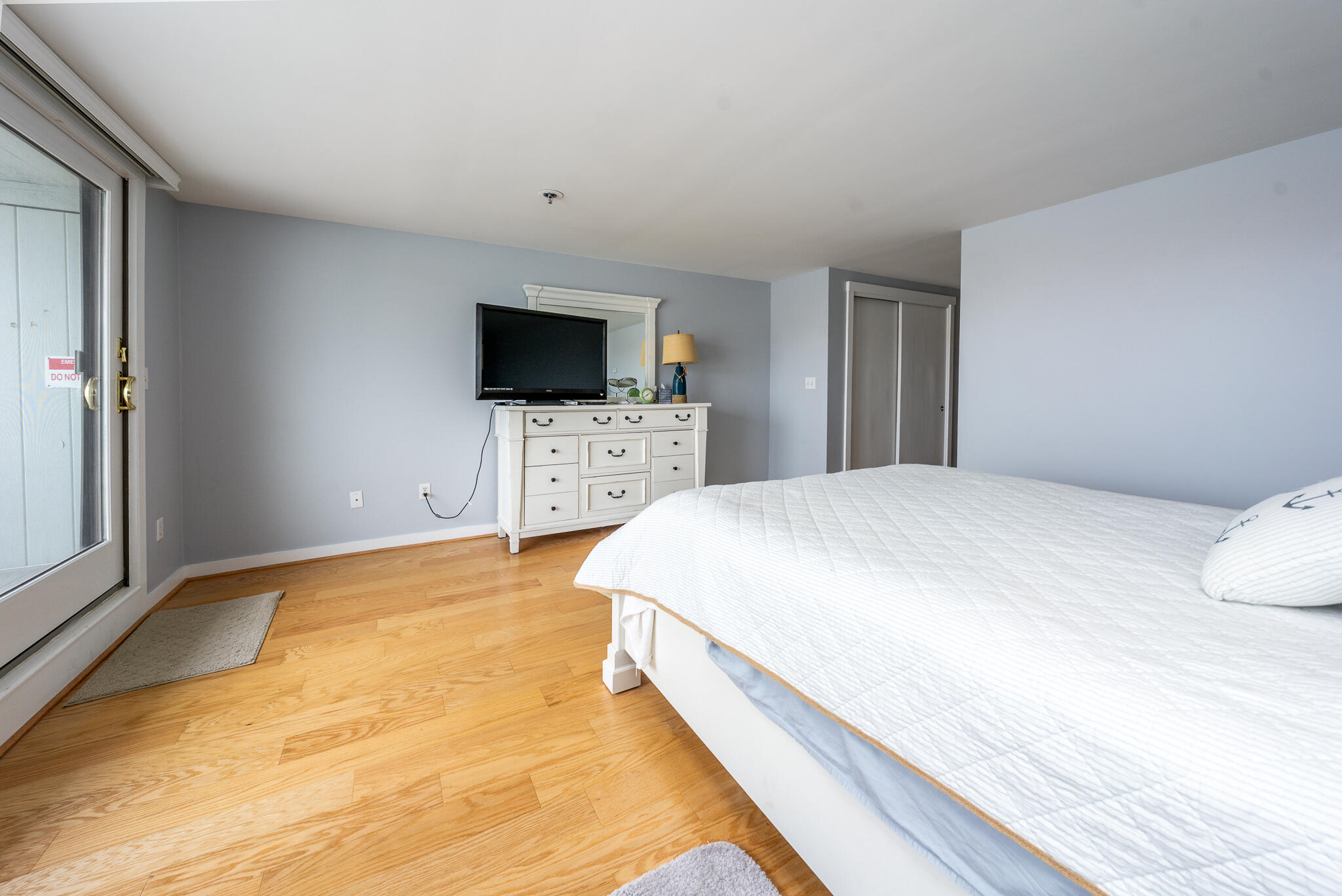 94 Shore Drive West, Unit 9B Mashpee, MA 02649 - Photo 17 of 35 a bedroom with a bed and a flat screen tv