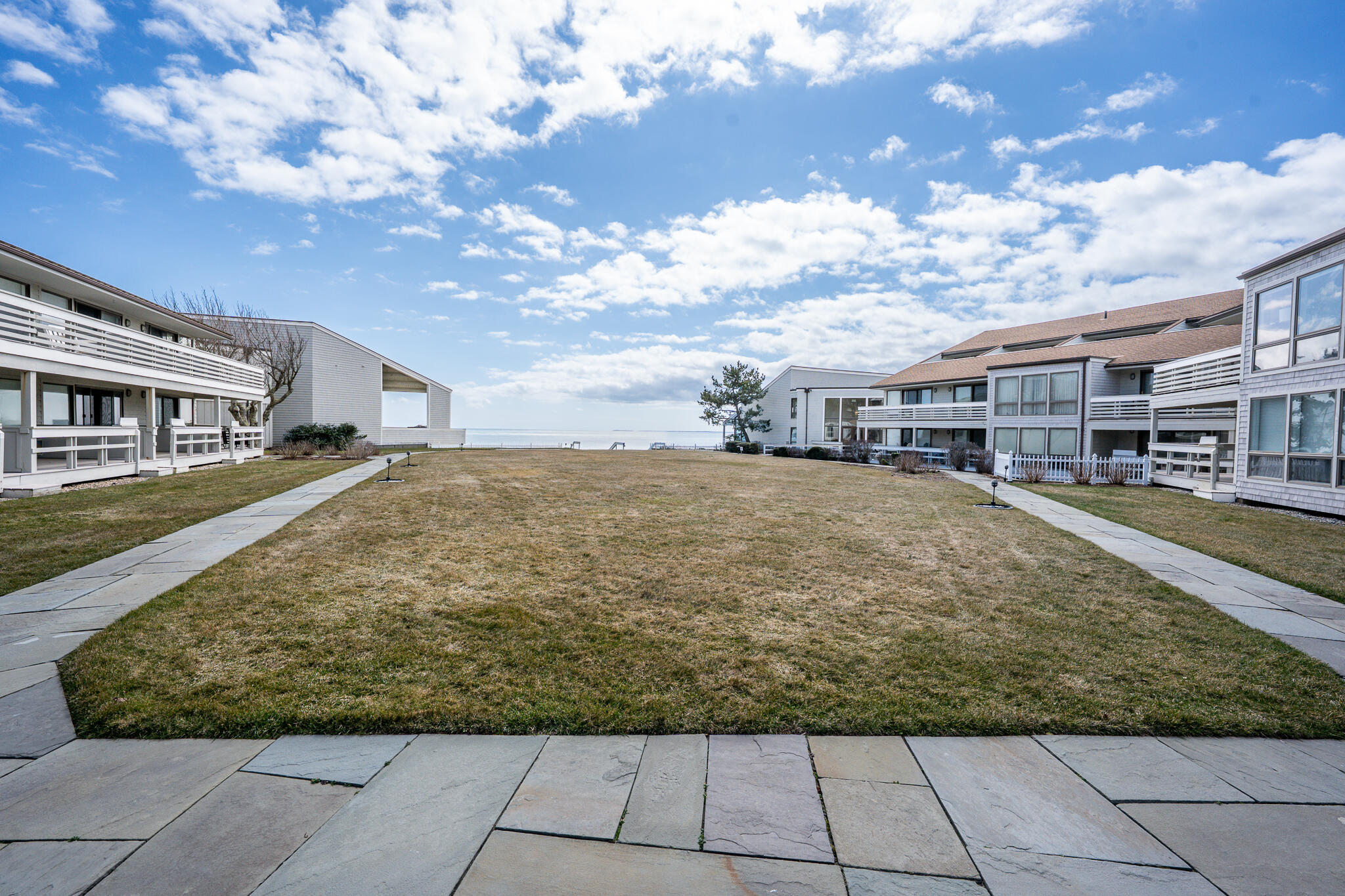 94 Shore Drive West, Unit 9B Mashpee, MA 02649 - Photo 28 of 35 a view of residential houses with yard