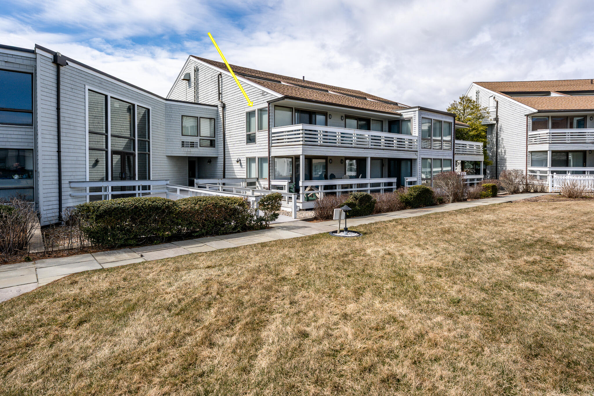 94 Shore Drive West, Unit 9B Mashpee, MA 02649 - Photo 30 of 35 a front view of a building with street view