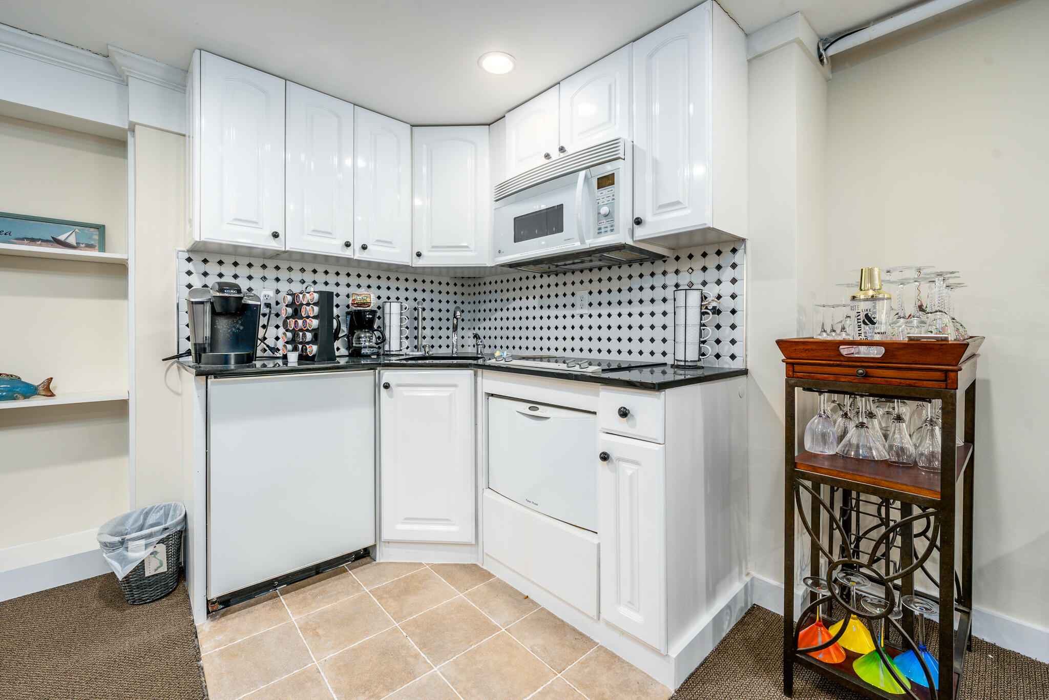 94 Shore Drive West, Unit 9B Mashpee, MA 02649 - Photo 34 of 35 a kitchen with stainless steel appliances granite countertop a stove a sink and a white cabinets