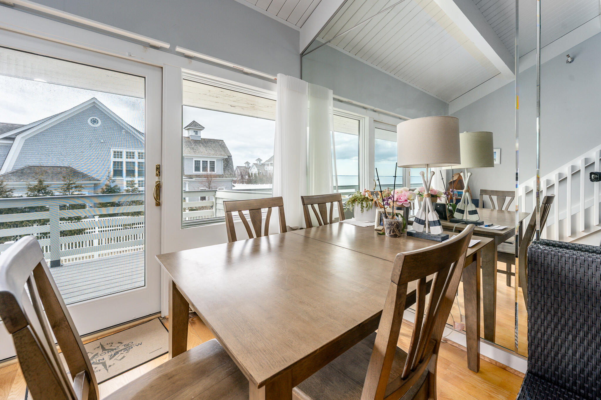 94 Shore Drive West, Unit 9B Mashpee, MA 02649 - Photo 5 of 35 a view of a dining room with furniture window and wooden floor