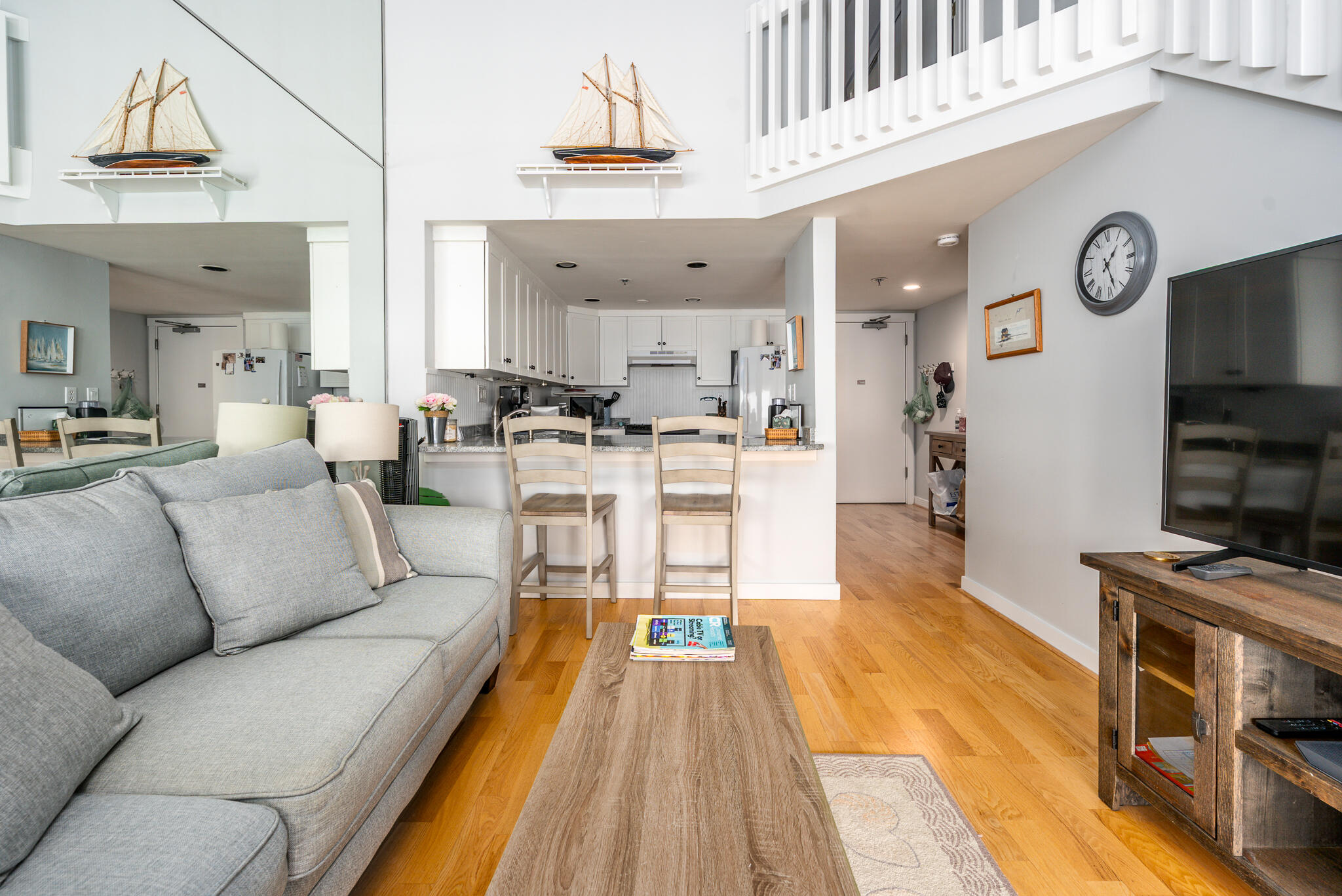 94 Shore Drive West, Unit 9B Mashpee, MA 02649 - Photo 8 of 35 a living room with furniture a rug and kitchen view