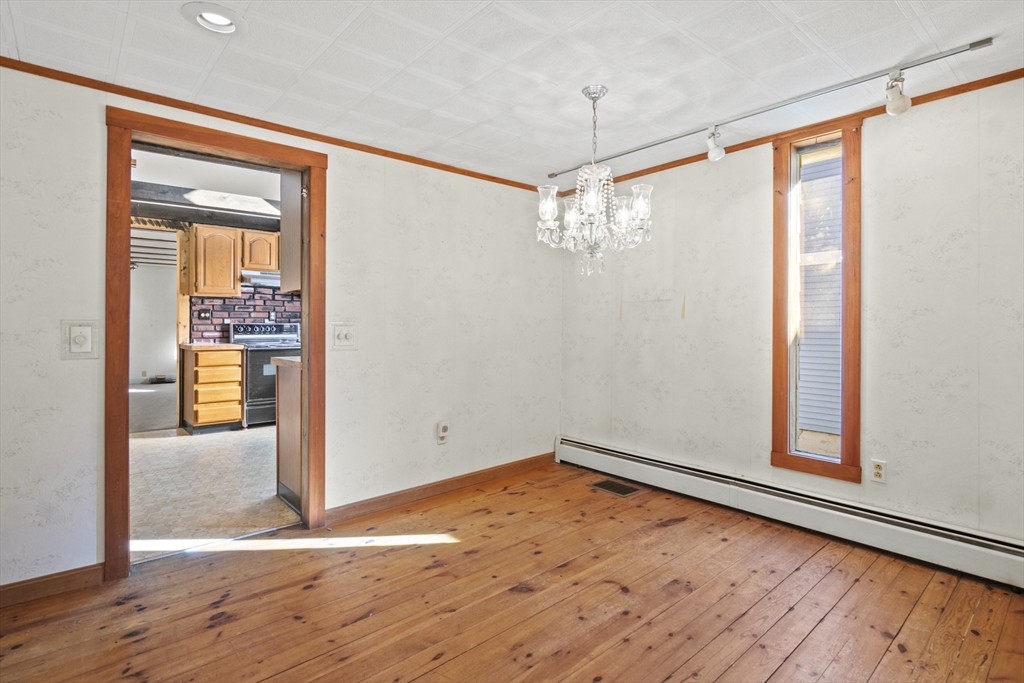 8 Mockingbird Hill Road Amesbury, MA 01913 - Photo 16 of 35 an empty room with wooden floor walk in closet and chandelier