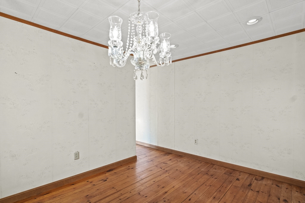 8 Mockingbird Hill Road Amesbury, MA 01913 - Photo 18 of 35 a view of a chandelier in big room with wooden floor