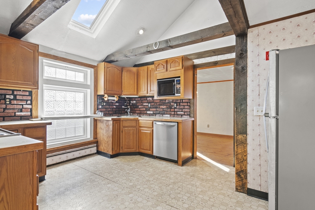 8 Mockingbird Hill Road Amesbury, MA 01913 - Photo 19 of 35 a kitchen with white cabinets and white appliances