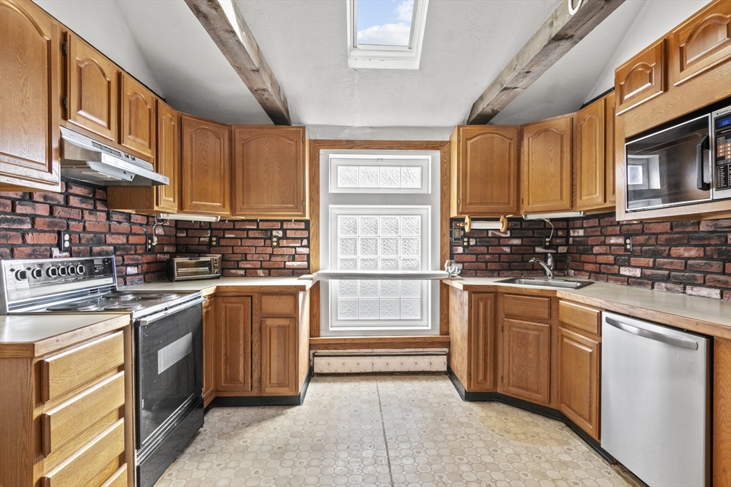 8 Mockingbird Hill Road Amesbury, MA 01913 - Photo 21 of 35 a kitchen with stainless steel appliances granite countertop a stove sink and cabinets