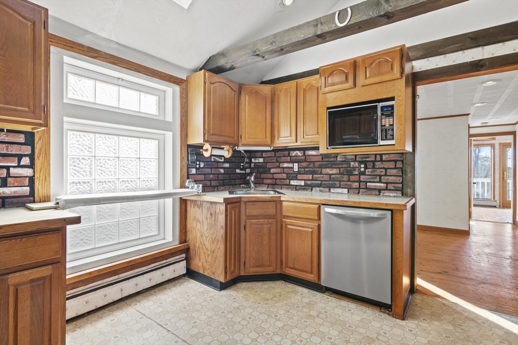 8 Mockingbird Hill Road Amesbury, MA 01913 - Photo 22 of 35 a kitchen with stainless steel appliances granite countertop a sink and a microwave