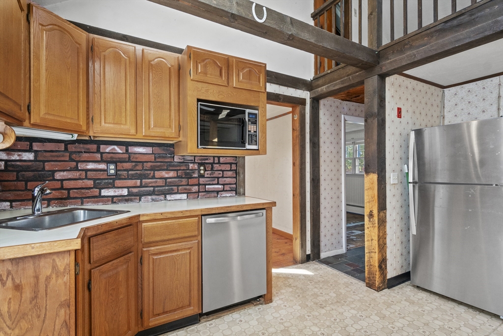 8 Mockingbird Hill Road Amesbury, MA 01913 - Photo 23 of 35 a kitchen with stainless steel appliances granite countertop a refrigerator and a sink