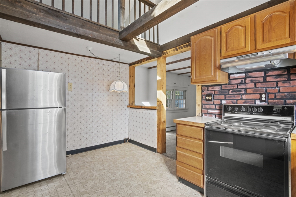 8 Mockingbird Hill Road Amesbury, MA 01913 - Photo 24 of 35 a kitchen with stainless steel appliances granite countertop a refrigerator and a stove