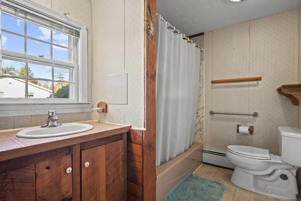 8 Mockingbird Hill Road Amesbury, MA 01913 - Photo 7 of 35 a bathroom with a sink a toilet and shower