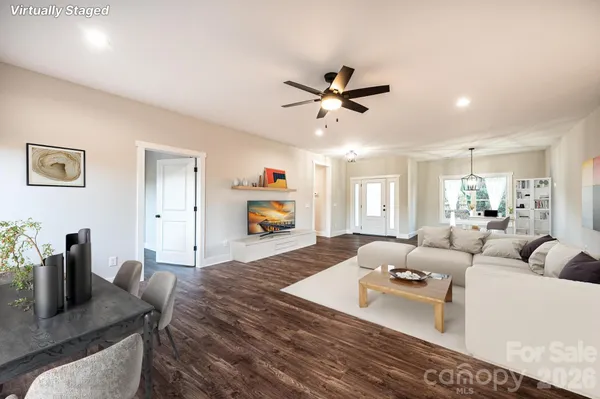 a living room with furniture and a wooden floor