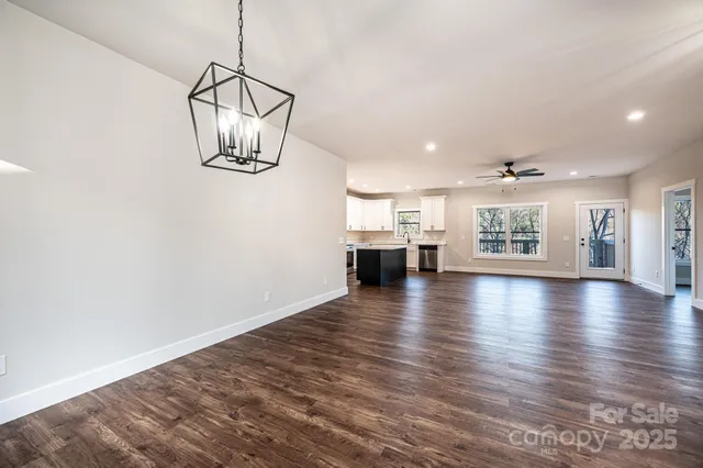 a view of a room with wooden floor and windows