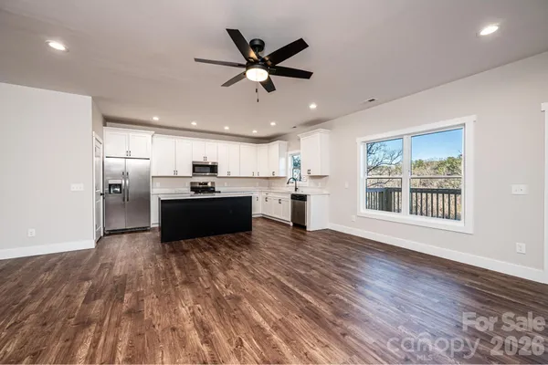 a kitchen with stainless steel appliances a refrigerator sink and cabinets