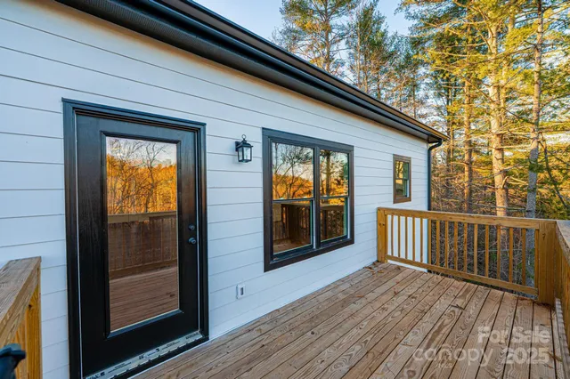 a view of a balcony with wooden floor and fence