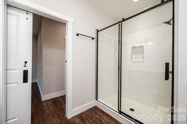 a bathroom with a shower and a glass door
