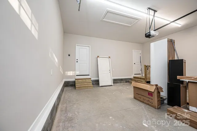 an empty room with wooden floor and ceiling fan
