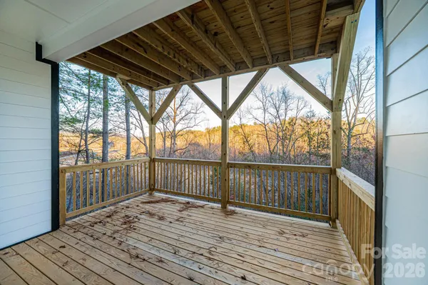 a view of porch with wooden floor