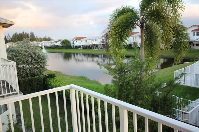 a balcony with wooden floor and yard in the back