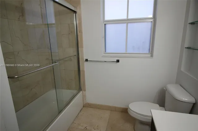 a bathroom with a toilet and a shower