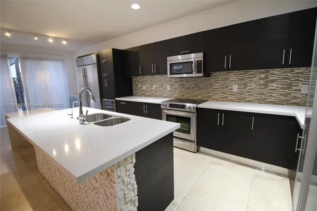 a kitchen with a sink and a refrigerator