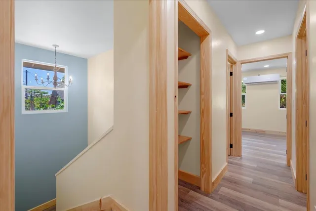 a view of a hallway with wooden floor