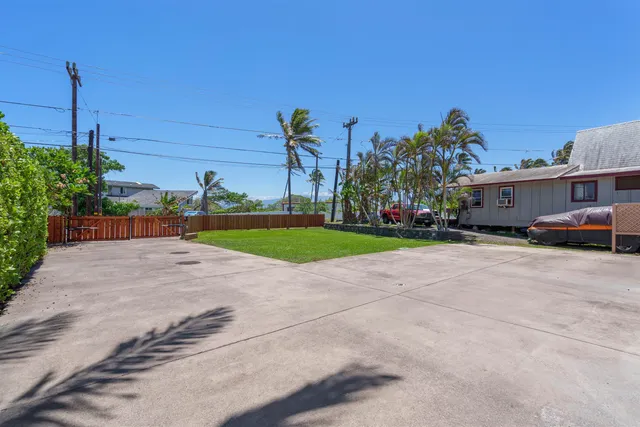 a view of a street with a cars park side of the road