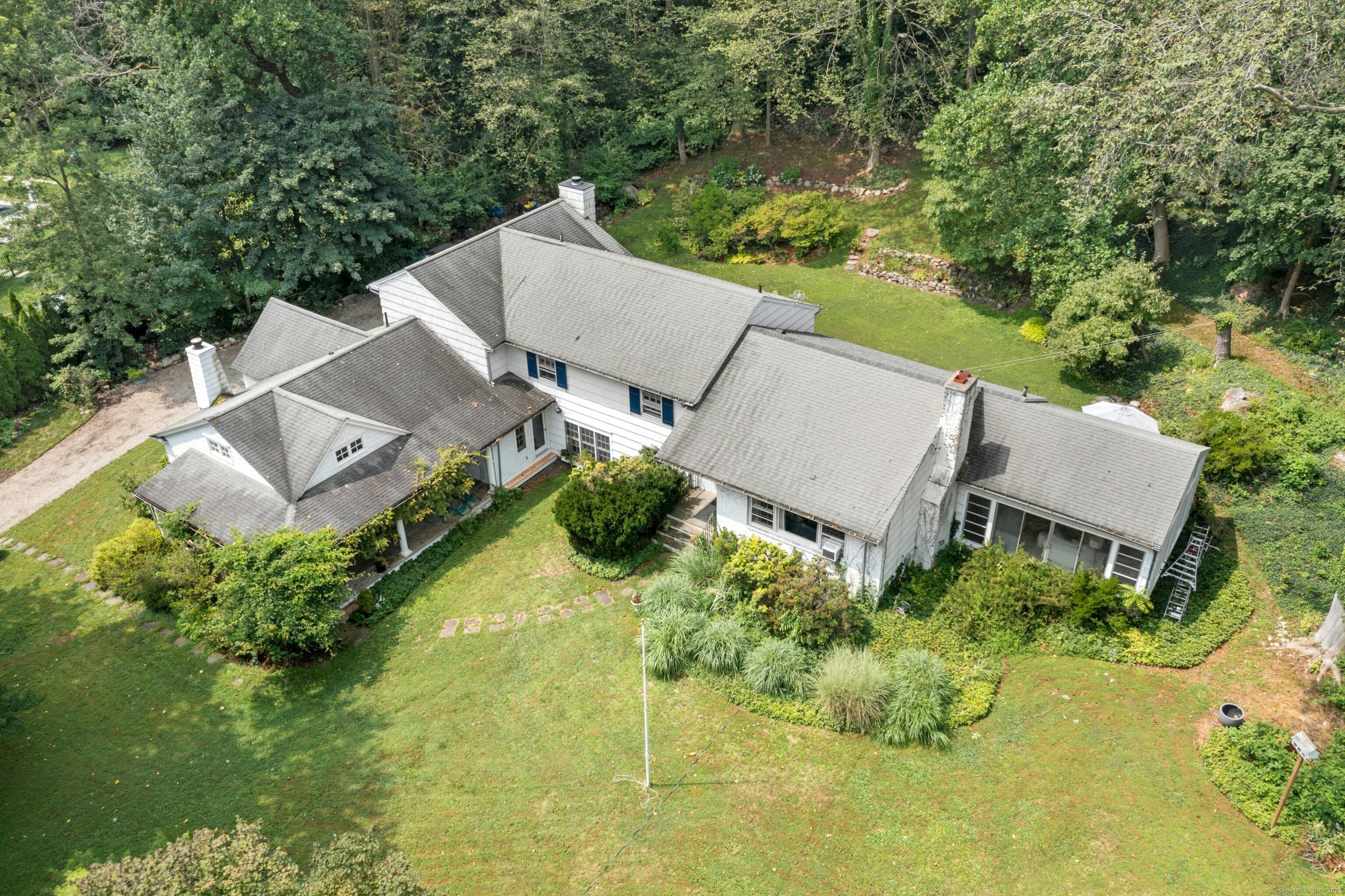 an aerial view of a house with pool garden and swimming pool