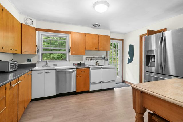 a kitchen with a window a sink and a refrigerator