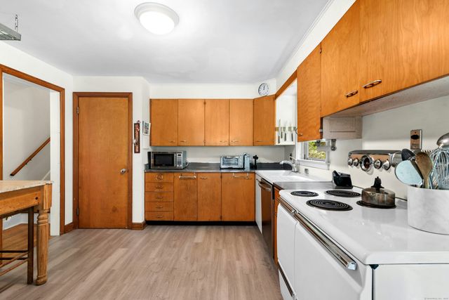 a kitchen with a stove a sink and a refrigerator