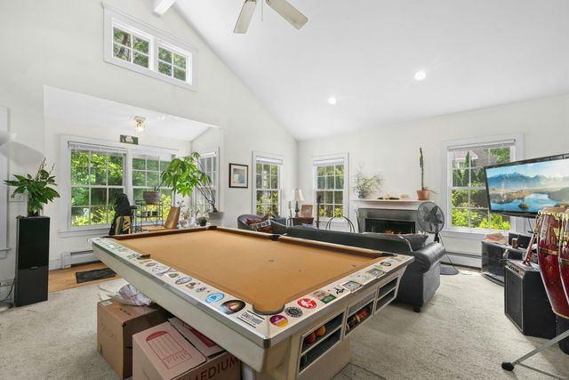 a room with furniture pool table table and chairs