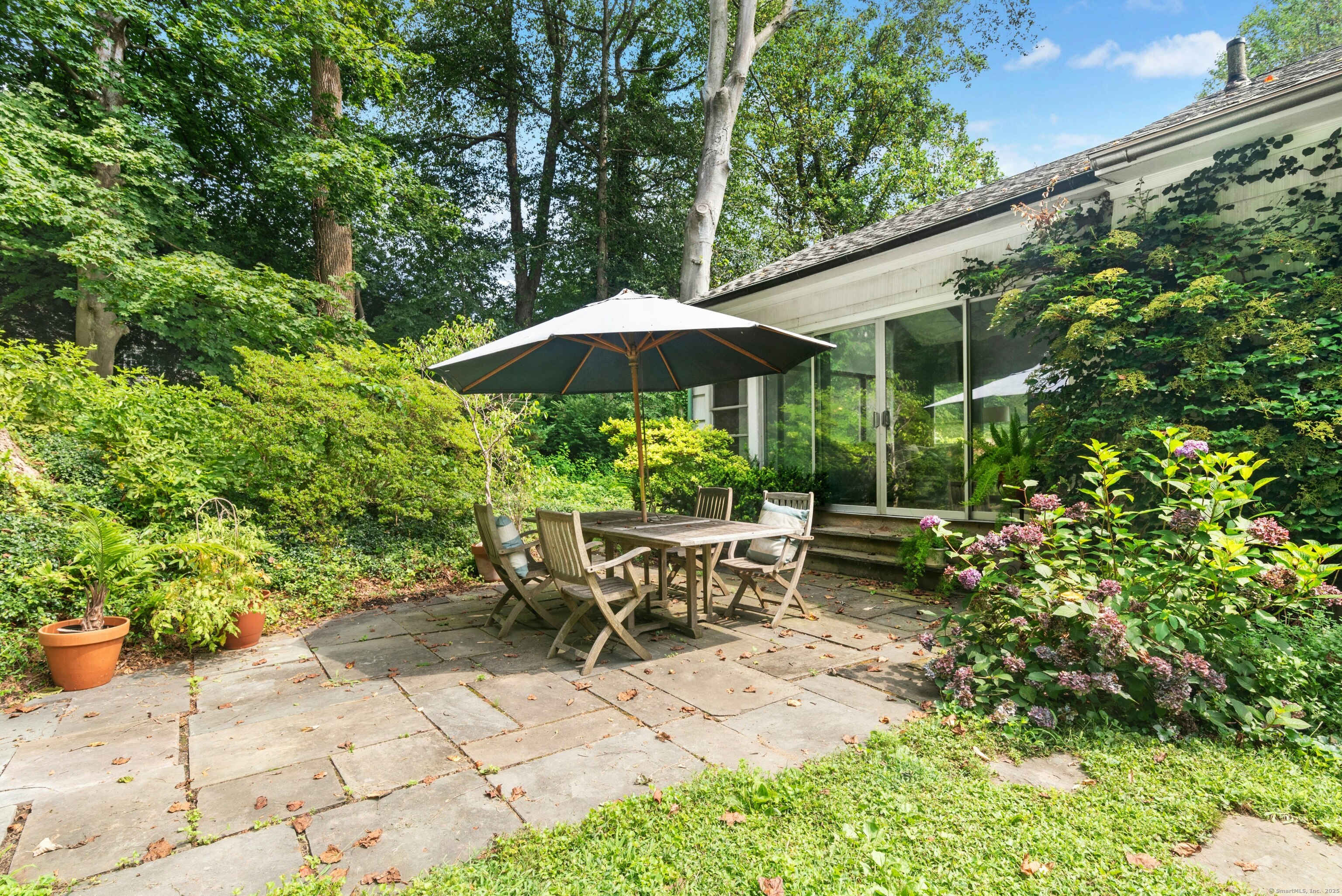 76 Deepwood Road Darien, CT 06820 - Photo 23 of 29 a view of backyard with seating space and trees