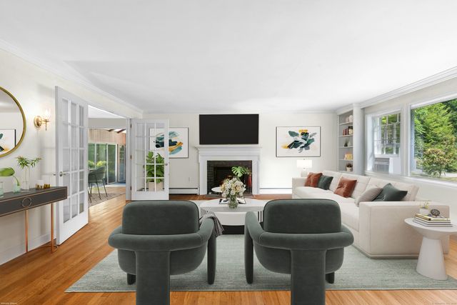 a living room with fireplace furniture and a flat screen tv