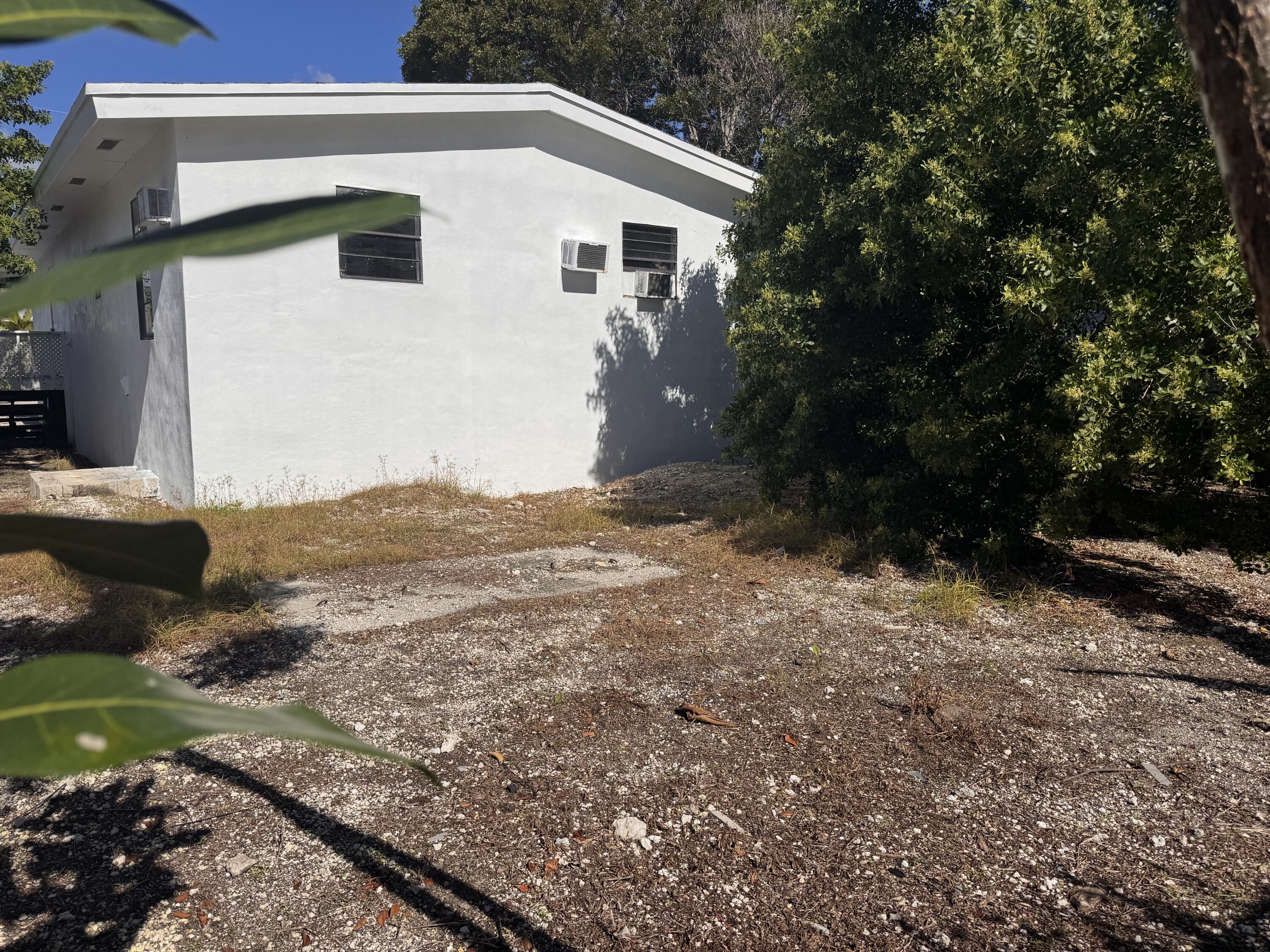 969 Plantation Road Key Largo, FL 33037 - Photo 25 of 26 a view of a house with a yard