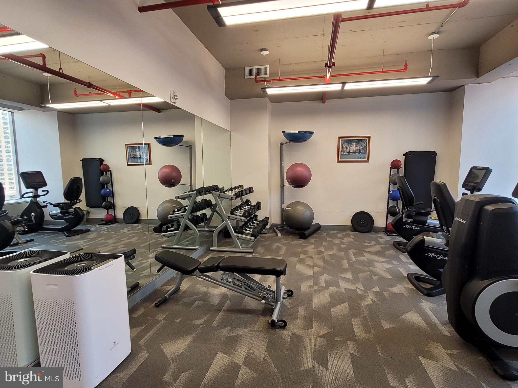135 South 19th Street, Unit 304 Philadelphia, PA 19103 - Photo 18 of 19 a view of a workspace with furniture and gym equipment