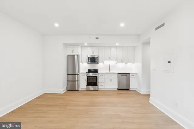 a view of a kitchen with refrigerator and microwave
