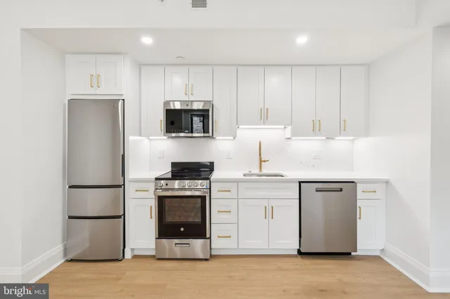 a kitchen with a refrigerator stove and microwave