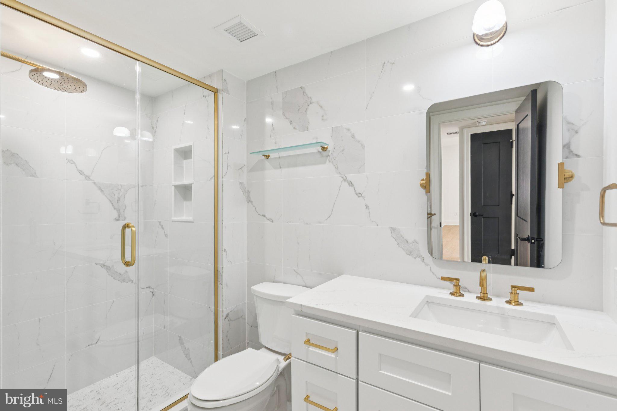 135 South 19th Street, Unit 304 Philadelphia, PA 19103 - Photo 9 of 19 a bathroom with a sink vanity mirror and toilet