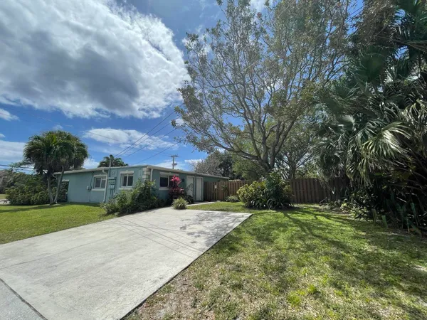 a view of a backyard with a garden and trees