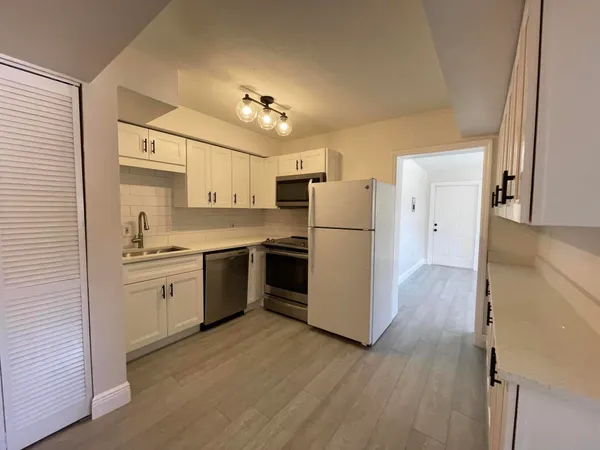 a kitchen with a refrigerator a sink and dishwasher