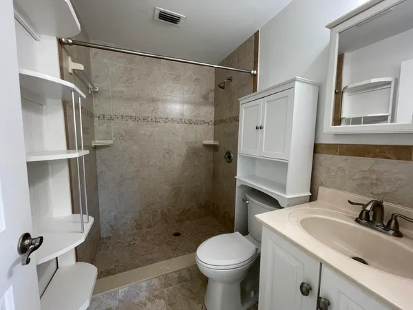 a bathroom with a sink toilet and shower