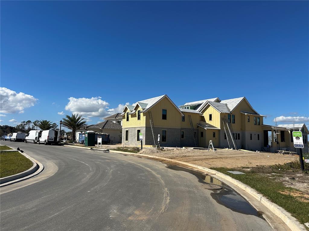 1227 Rdg Lk Way Oakland, FL 34787 - Photo 2 of 5 a front view of a building with a yard