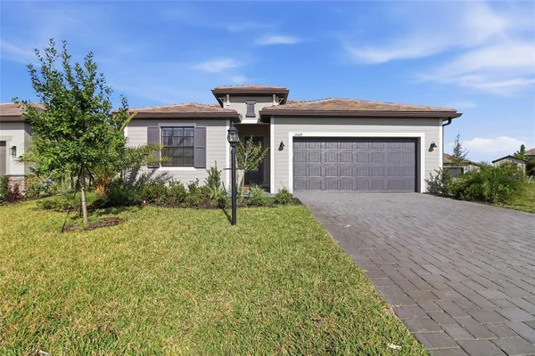 a front view of a house with a yard and garage