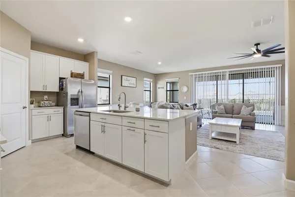 a kitchen with stainless steel appliances a stove a sink a microwave and cabinets