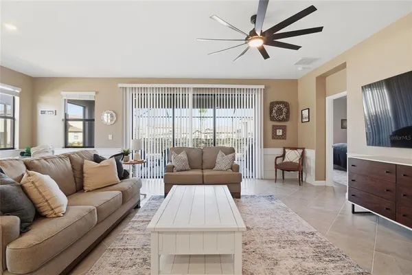 a living room with furniture kitchen and a table