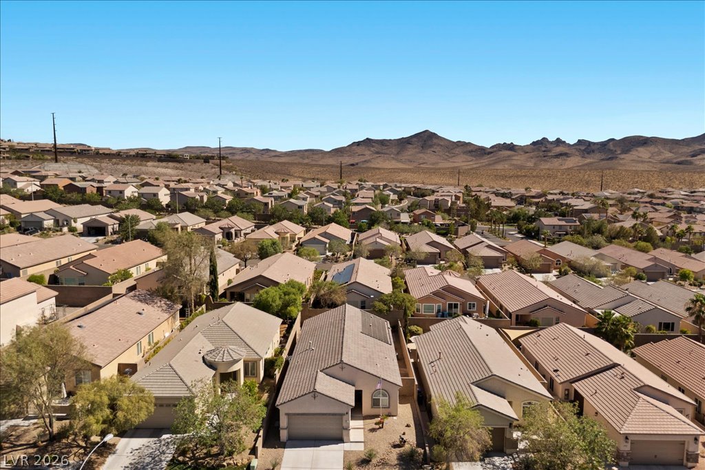 2627 Dirleton Place Henderson, NV 89044 - Photo 37 of 42 An aerial perspective reveals a residential community nestled against a rugged, arid mountain landscape.