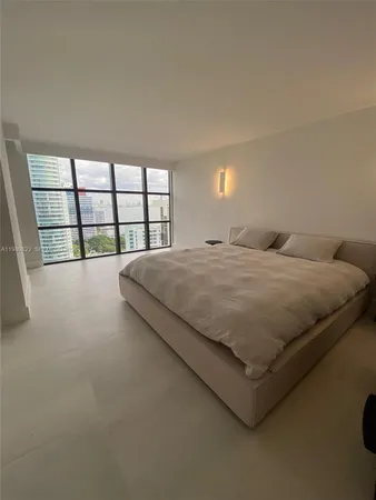 a large bed sitting in a bedroom with a tv