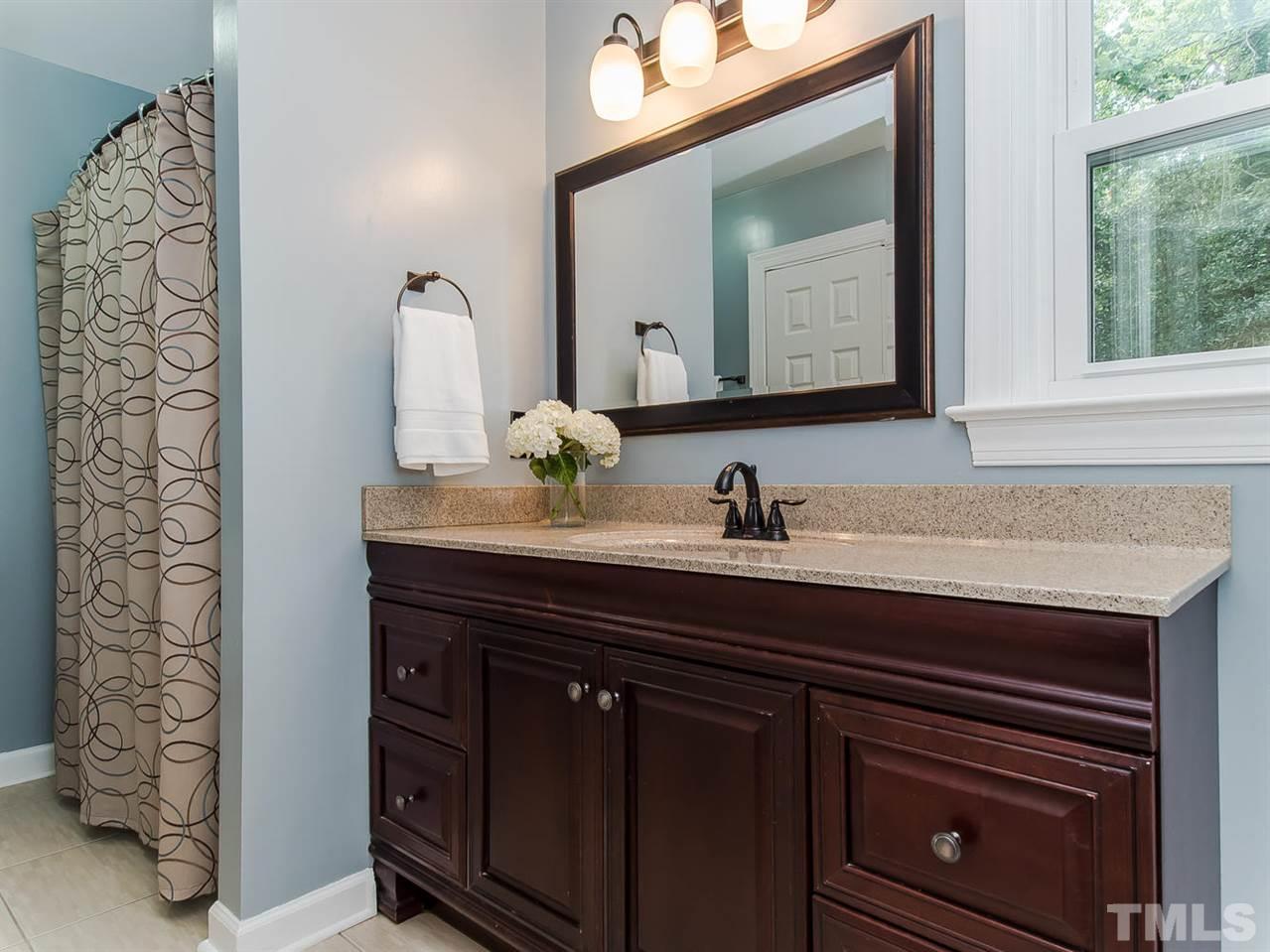5105 Carter Street Raleigh, NC 27612 - Photo 22 of 25 a bathroom with a sink and a mirror