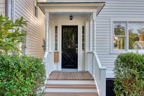 a front view of a house with a garden