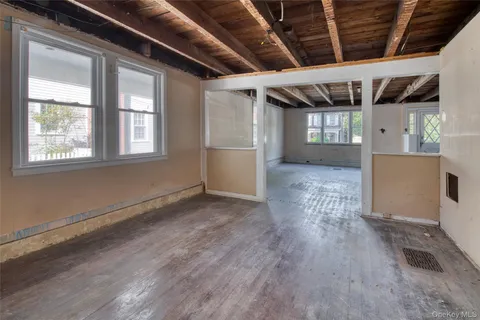 a view of a room with wooden floors and windows