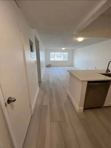 a view of a hallway with wooden floor